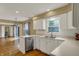 Open kitchen with white cabinets, stainless steel appliances and a view to the spacious living area at 40 Twinshore Ct, Carmel, IN 46033