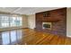Spacious living room with hardwood floors, large window and a brick fireplace with wood mantel at 40 Twinshore Ct, Carmel, IN 46033