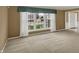 Bright living room showcasing a large window with a view, neutral carpet, and a welcoming entrance at 40 Twinshore Ct, Carmel, IN 46033