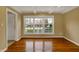 Empty living room showcasing hardwood floors, fresh paint and natural light from the large windows at 40 Twinshore Ct, Carmel, IN 46033