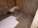 Unfinished basement featuring exposed wood flooring, insulation, and debris at 413 W 8Th St, Muncie, IN 47302