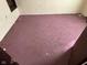 Bedroom features damaged purple carpeting and white walls at 413 W 8Th St, Muncie, IN 47302