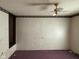 Bedroom with white walls, patterned wallpaper border, and ceiling fan at 413 W 8Th St, Muncie, IN 47302