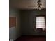 Bedroom featuring a ceiling fan, and a window with curtains at 413 W 8Th St, Muncie, IN 47302