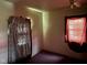 Dimly lit bedroom featuring a window, ceiling fan, and dark carpet at 413 W 8Th St, Muncie, IN 47302