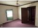 Bedroom featuring window with tattered curtains and doorway at 413 W 8Th St, Muncie, IN 47302