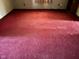 Spacious room with red carpet and natural light, ready for personalization at 413 W 8Th St, Muncie, IN 47302