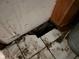 Close up of a damaged tile floor next to a wall with damaged paint at 413 W 8Th St, Muncie, IN 47302