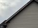 Close-up view of the roofline and exterior vinyl siding of the two-story home at 413 W 8Th St, Muncie, IN 47302