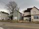 Street view of a two-story home with boarded windows at 413 W 8Th St, Muncie, IN 47302