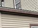Close-up view of the exterior siding and trim, showing some mold, mildew, and deterioration at 413 W 8Th St, Muncie, IN 47302