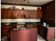 Kitchen featuring wood cabinets and tile floors at 413 W 8Th St, Muncie, IN 47302