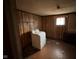 Laundry area with wood paneling featuring a laundry machine and a small window at 413 W 8Th St, Muncie, IN 47302