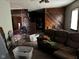 Living room with hardwood floors, a couch, and a brick wall at 413 W 8Th St, Muncie, IN 47302