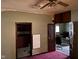 This room features an old ceiling fan, 2 doorways and wood-look floors at 413 W 8Th St, Muncie, IN 47302