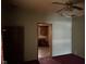 This room features wood floors, ceiling fan and an open doorway to a room with a red chair at 413 W 8Th St, Muncie, IN 47302