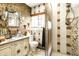 Bathroom features a retro, patterned tile shower, a framed mirror and a vintage vanity at 424 E Vermont St, Indianapolis, IN 46202