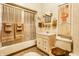 Bathroom featuring ceramic tiled walls, a vanity with a sink and a bathtub with sliding doors at 424 E Vermont St, Indianapolis, IN 46202