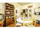 Quaint dining area featuring vintage wood shelf and sunny dining table with yellow chairs at 424 E Vermont St, Indianapolis, IN 46202