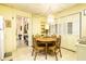 Charming dining area featuring a round wooden table, seating for four, and elegant chandelier lighting at 424 E Vermont St, Indianapolis, IN 46202