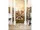 Elegant dining room with columns framing a view of the living room, creating a sense of spaciousness and connection at 424 E Vermont St, Indianapolis, IN 46202