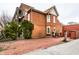 A charming vintage brick house with a red brick driveway, a fenced yard, and mature trees at 424 E Vermont St, Indianapolis, IN 46202