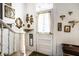 Bright hallway features a vintage front door, decorative mirrors, and a winding staircase at 424 E Vermont St, Indianapolis, IN 46202