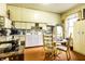 Functional kitchen with classic cabinets and a cozy dining nook with vintage appliances at 424 E Vermont St, Indianapolis, IN 46202