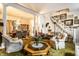 Elegantly decorated living room with a vintage fireplace, plush armchairs, and open access to the dining area at 424 E Vermont St, Indianapolis, IN 46202