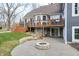 Beautiful backyard with a stone fire pit, deck, and stairs down to the patio and yard at 4915 E 79Th St, Indianapolis, IN 46250