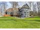 Stunning backyard view featuring a deck, patio with fire pit, and a lush green lawn at 4915 E 79Th St, Indianapolis, IN 46250