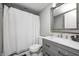 Bathroom featuring modern gray cabinets, a white shower curtain, and a vanity at 4915 E 79Th St, Indianapolis, IN 46250