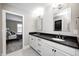 Modern bathroom with a double vanity featuring black countertops and sleek fixtures at 4915 E 79Th St, Indianapolis, IN 46250