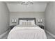 Bedroom with sloped ceilings, featuring a modern light fixture and neutral decor at 4915 E 79Th St, Indianapolis, IN 46250
