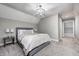 Comfortable bedroom with sloped ceilings, featuring a modern light fixture and neutral decor at 4915 E 79Th St, Indianapolis, IN 46250