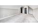Large room with carpet flooring, base molding, light gray walls, and black doors at 4915 E 79Th St, Indianapolis, IN 46250