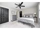 Comfortable bedroom with a ceiling fan, black doors, and a charming dresser adding unique character at 4915 E 79Th St, Indianapolis, IN 46250