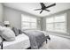 Serene bedroom with neutral tones, featuring a ceiling fan and large windows offering ample natural light at 4915 E 79Th St, Indianapolis, IN 46250