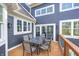 Outdoor dining on the deck with a table and seating, overlooking a well-maintained backyard at 4915 E 79Th St, Indianapolis, IN 46250