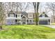 Charming two-story home featuring stone accents, gray siding, and a well-manicured lawn at 4915 E 79Th St, Indianapolis, IN 46250