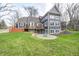 Rear exterior of home showcasing a deck, patio, fire pit area, and landscaped backyard at 4915 E 79Th St, Indianapolis, IN 46250