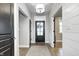 Bright entryway features hardwood floors, a decorative light fixture, and stylish doors at 4915 E 79Th St, Indianapolis, IN 46250