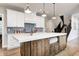 Kitchen island with white countertop, custom cabinets, and wood floors at 4915 E 79Th St, Indianapolis, IN 46250