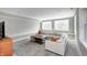 A finished basement living room featuring a sectional sofa, windows, and carpet flooring at 4915 E 79Th St, Indianapolis, IN 46250