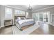 Spacious main bedroom featuring a large bed, chandelier, and sliding glass doors at 4915 E 79Th St, Indianapolis, IN 46250
