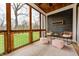 Inviting screened-in porch featuring wood ceiling, cozy seating, and view of the outdoors at 4915 E 79Th St, Indianapolis, IN 46250