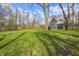 Expansive yard view showcasing lush green grass, mature trees, and the house in the background at 4915 E 79Th St, Indianapolis, IN 46250