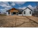 Exterior of a new home with a black roof, white siding and a covered back porch at 5123 Oak Ridge Pl, Columbus, IN 47201