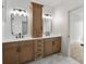 A bright bathroom features a double sink vanity and a large mirror at 5123 Oak Ridge Pl, Columbus, IN 47201