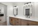 Bathroom with double sinks, wood cabinets, and modern black fixtures at 5123 Oak Ridge Pl, Columbus, IN 47201